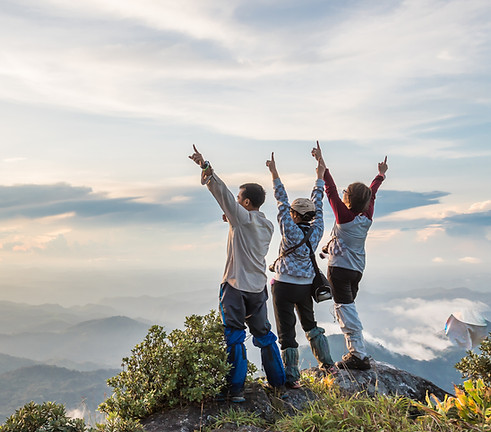 Hikers celebrating at sunset
